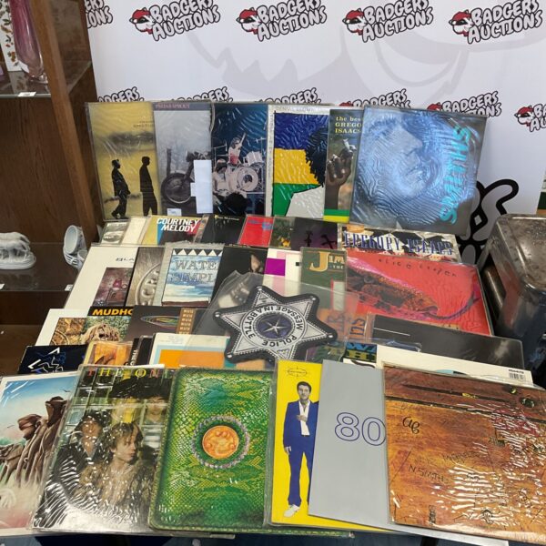 Vinyl record collection including The Police picture disc and Alice Cooper albums.