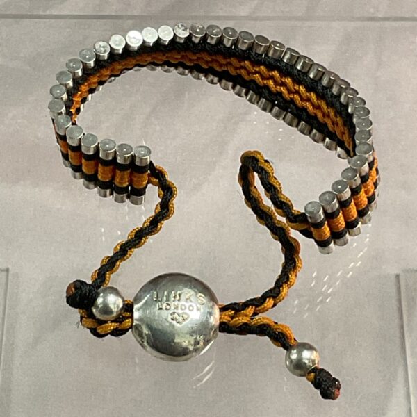 Close-up of Links of London woven bracelet with silver beads.