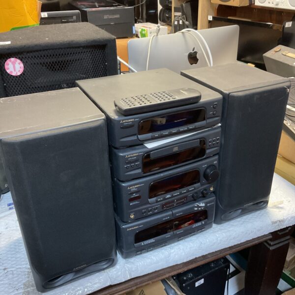 Black Mitsubishi hi-fi system with speakers and remote control.