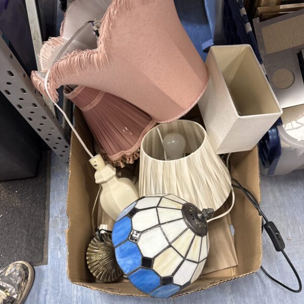 Assorted vintage table lamps and shades in a cardboard box.