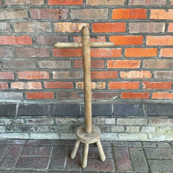 Vintage wooden washing dolly stick for laundry.
