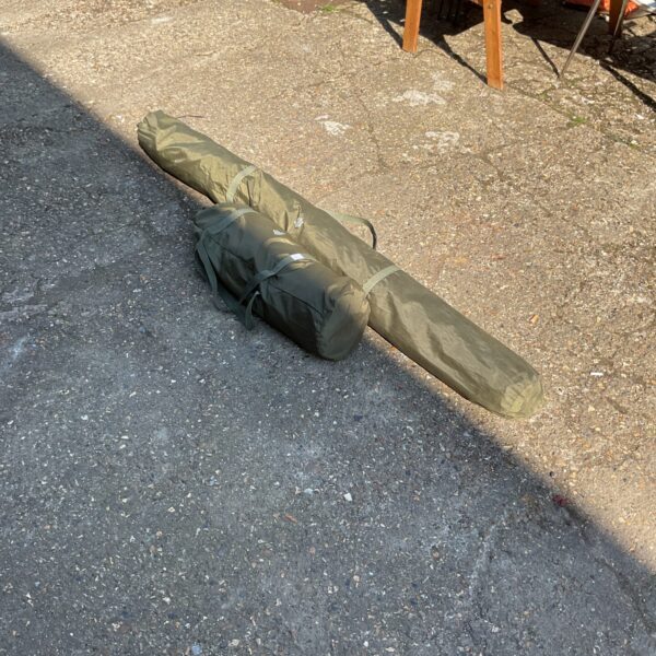 Rolled JRC carp fishing bivvy in a carry bag.