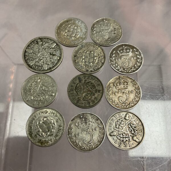 Collection of vintage silver threepenny coins for collectors.