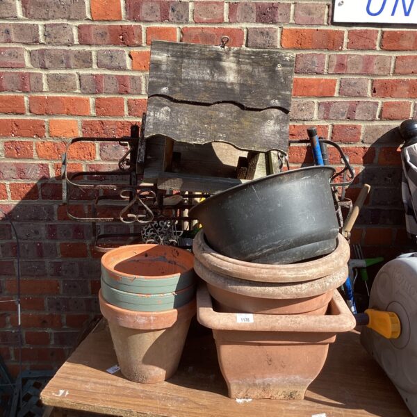 Vintage garden bird table top with terracotta pots.