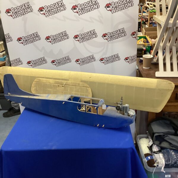 Wooden scratch-built RC airplane model on display.