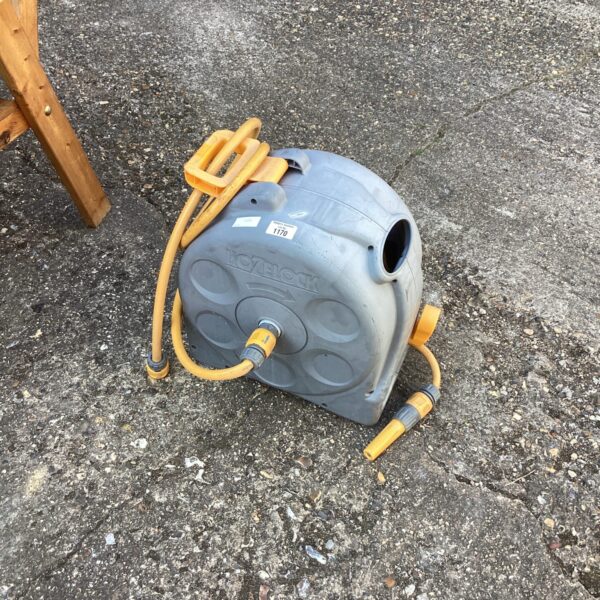 Vintage Hozlock garden hose reel for outdoor watering.