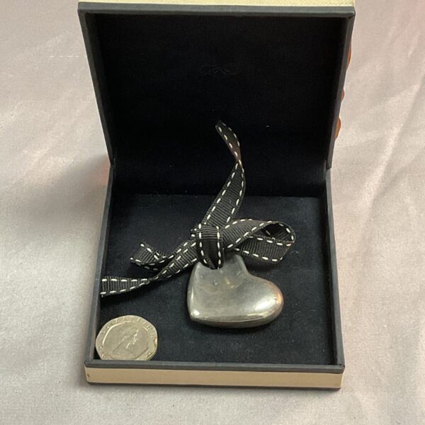 Hallmarked silver Links of London heart pendant on display.