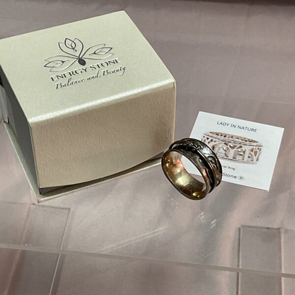 Close-up of Energy Stone silver Tsunami art ring with textured design.