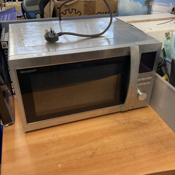 Stainless steel Sharp combination microwave oven for kitchen use.