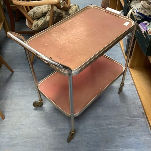 Vintage serving trolley with tiered metal shelves.