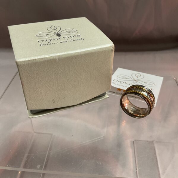 Silver spinner ring with energy stone and rotating bands.