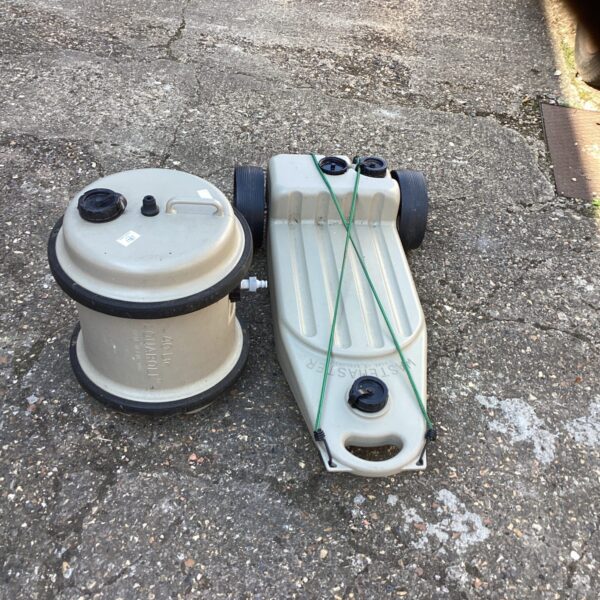 Grey plastic water butt unit for garden rainwater collection.