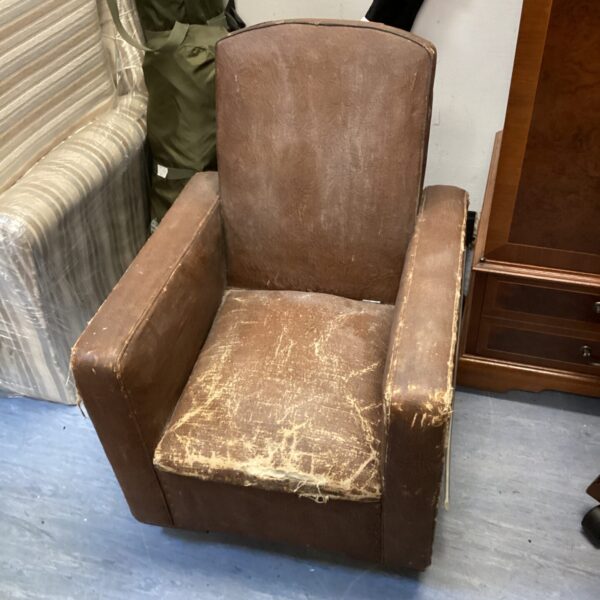 Vintage leather kids chair with wear and patina.