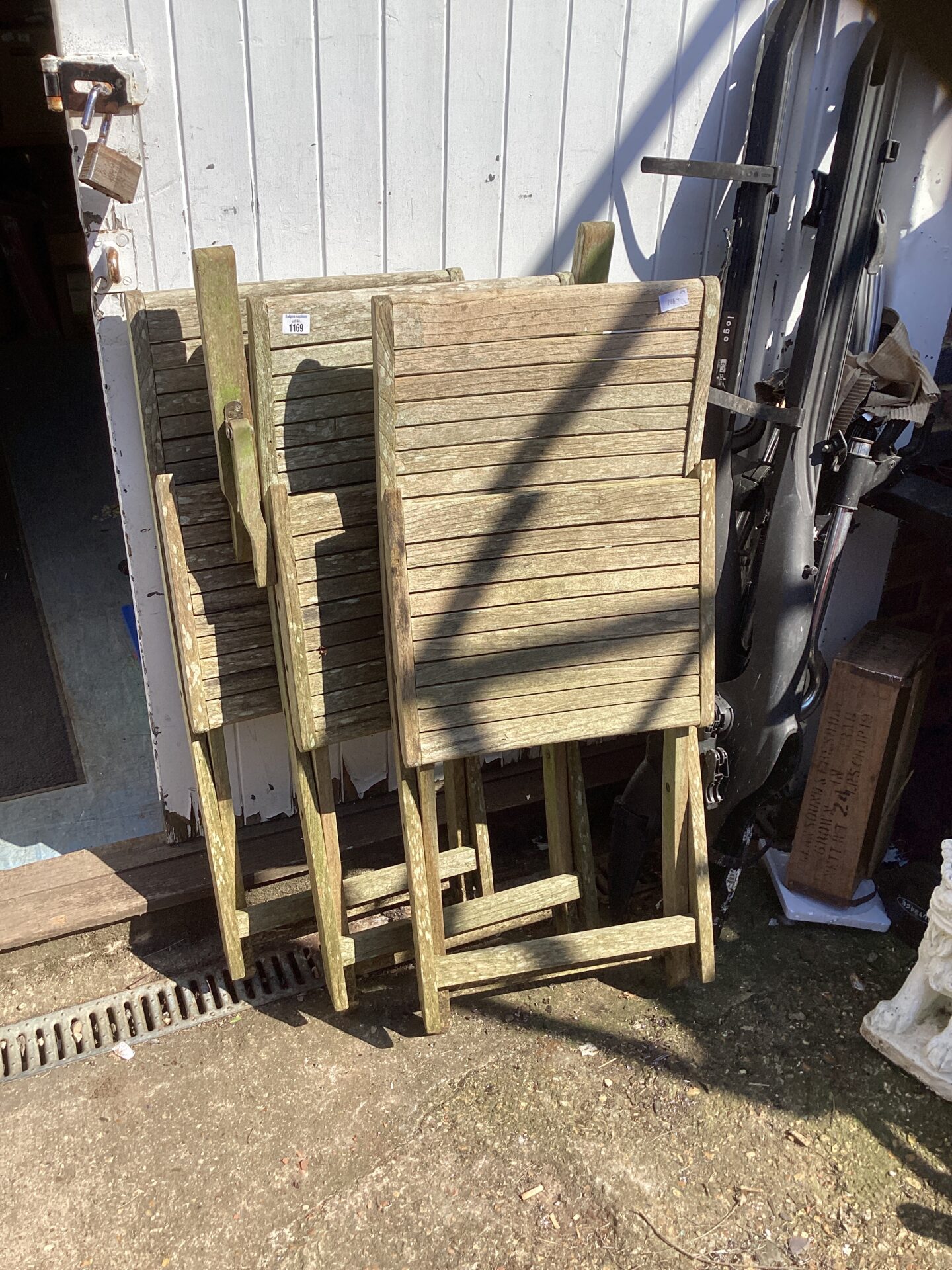 1169 Three Teak folding garden chairs