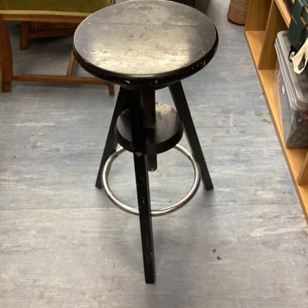 Vintage adjustable wooden stool with black finish.