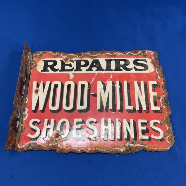 Vintage Wood-Milne enamel sign advertising shoeshines and repairs.