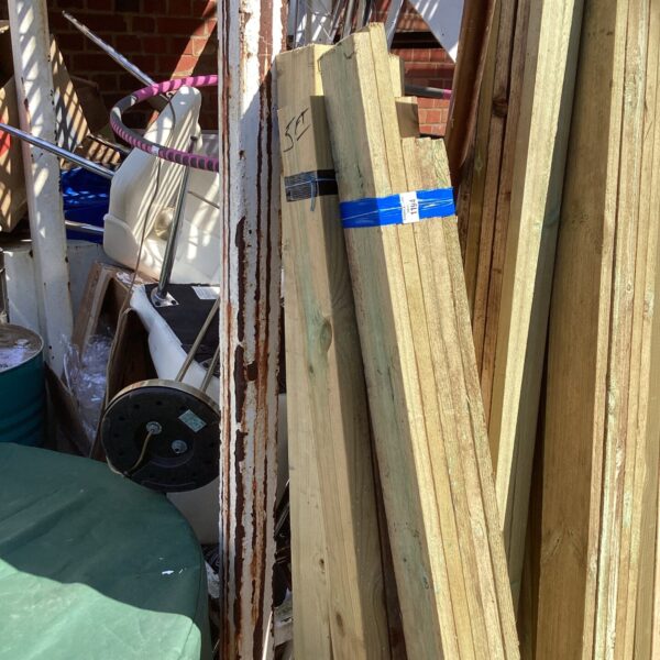 Three bundles of timber stored outdoors, ready for DIY projects.