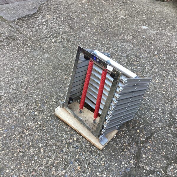 Aluminium folding loft ladder for attic access, showing hinged sections.