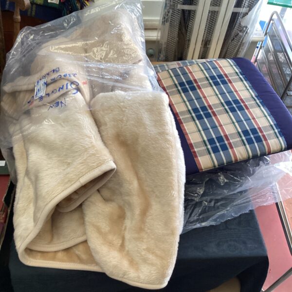 Cream fleece blanket presented in packaging, soft and cosy.