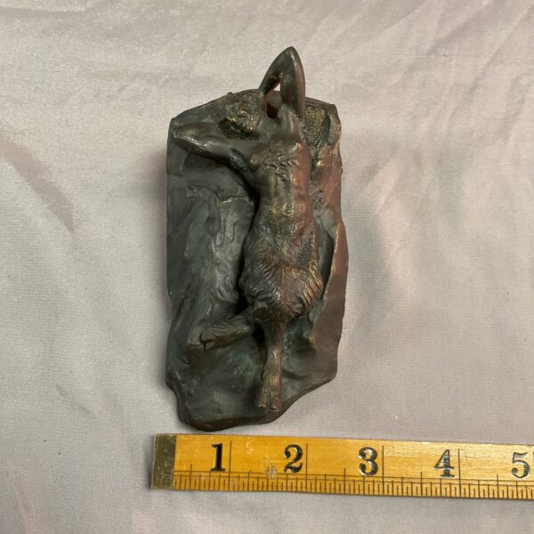 Antique bronze sculpture of a reclining Pan figure.