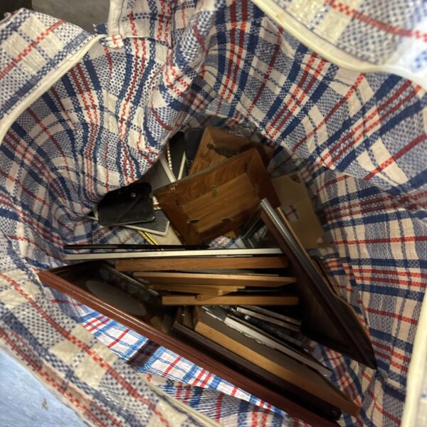 Assorted vintage picture frames in a bag, ready for crafting.