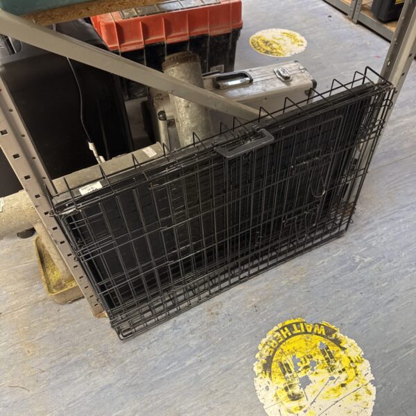 Wire folding pet cage for animal transport and travel.