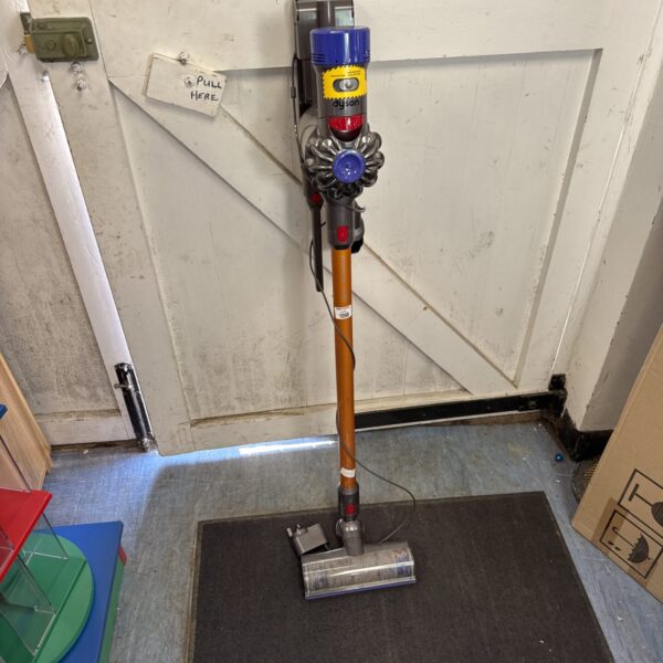 Used Dyson V8 Absolute cordless vacuum cleaner in a home setting.