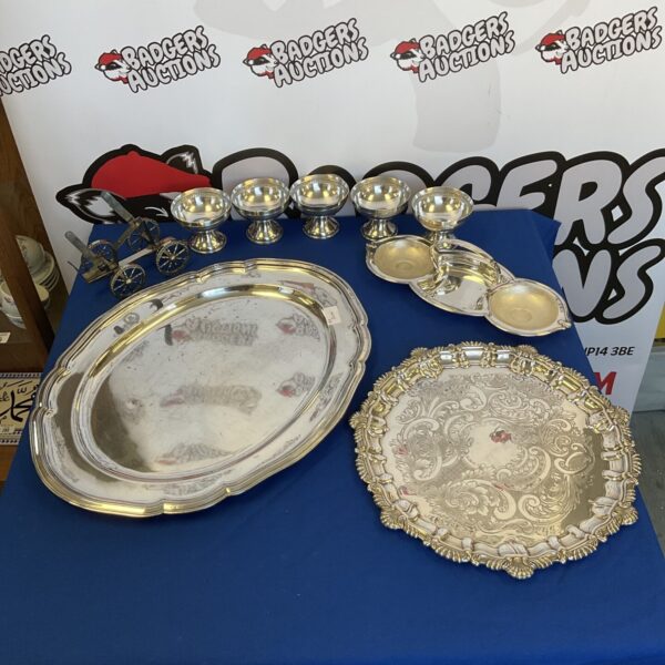 Ornate silver plate serving tray with detailed embossed design.