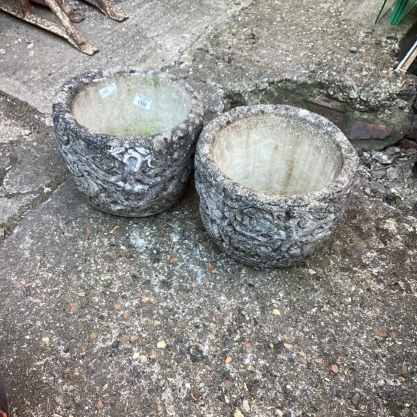 Two stone effect garden planters for outdoor plants.