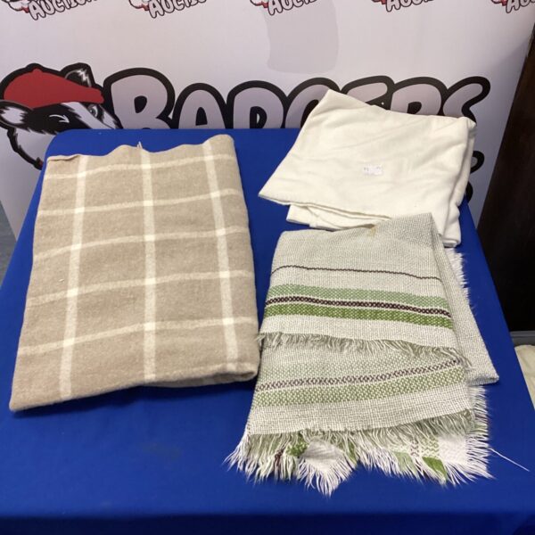 Lot of three vintage throw blankets with patterned designs.