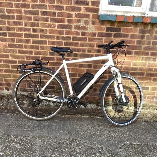 Side view of a grey Cube electric bike with accessories.