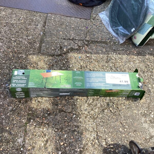 Aluminium folding table in original packaging, ready for use.