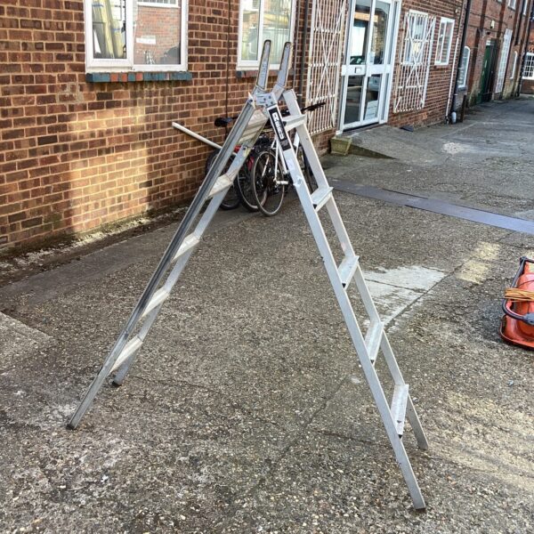 Silver Abru aluminium convertible ladder in a garden setting.