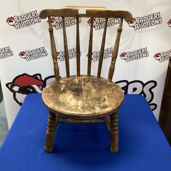 Antique oak nursing chair with shaped back and seat.