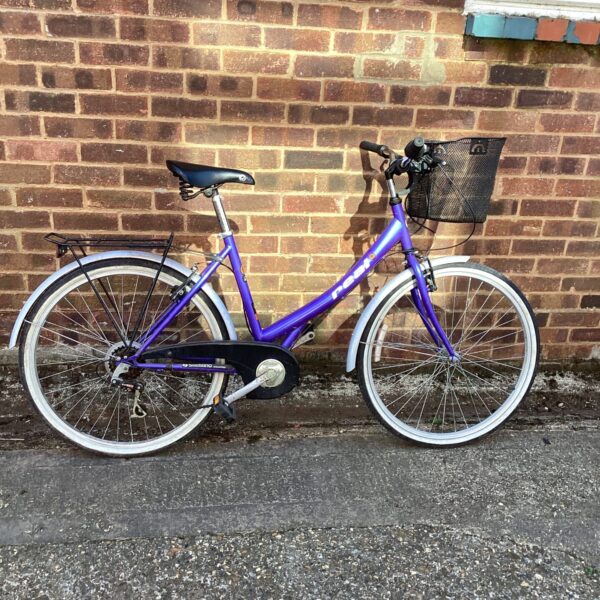 Purple vintage ladies bicycle with basket and rack.