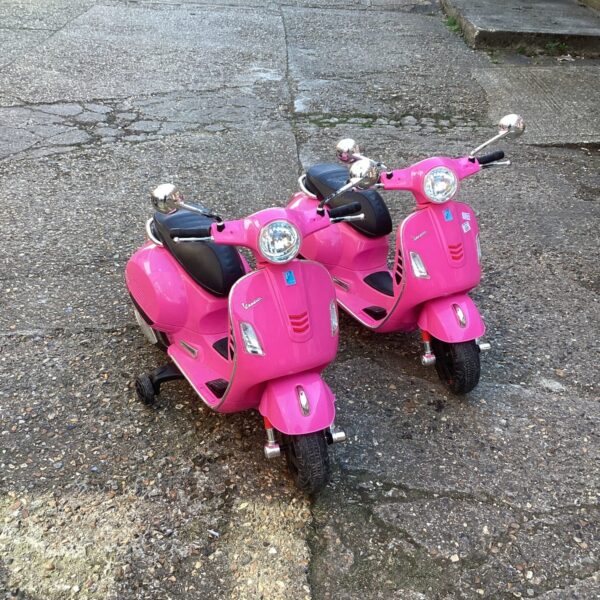 Pair of childs vespa ride on scooters