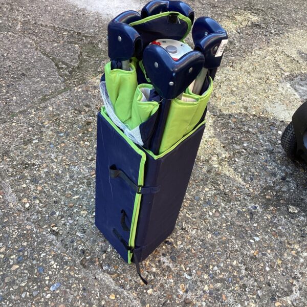 Folded travel cot showing portable design and fabric construction.