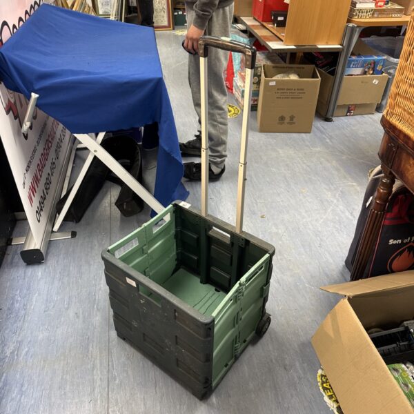 Blue and green plastic folding trolley for light duty transport.