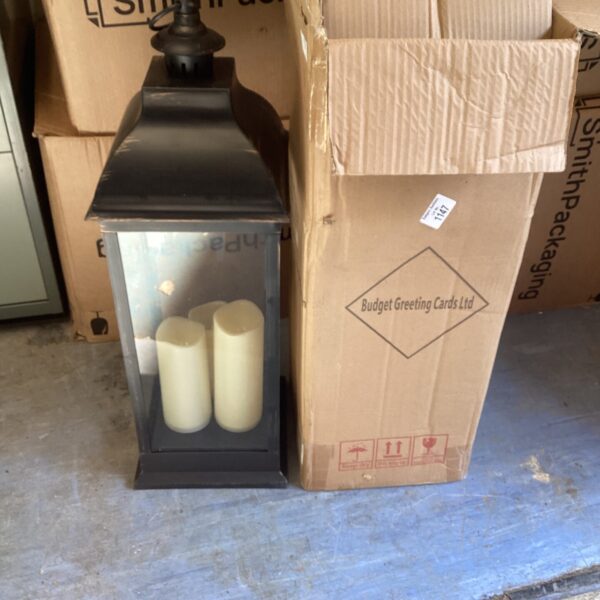 Two tall battery powered lanterns in used condition.