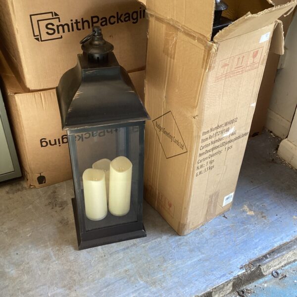 Pair of dark metal battery powered lanterns for garden or home decor.