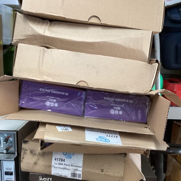 Stack of six boxes of party invitation packs for celebrations.