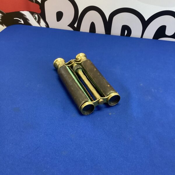Antique brass binoculars with leather grip, vintage collectible optics.