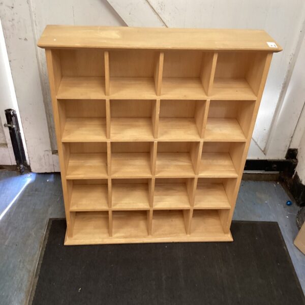 Vintage pine display shelving unit with multiple compartments.