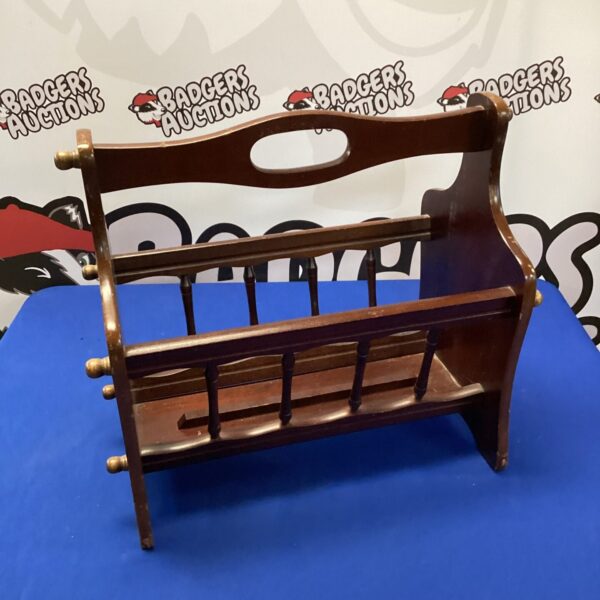 Vintage dark wood magazine rack for holding magazines and periodicals.