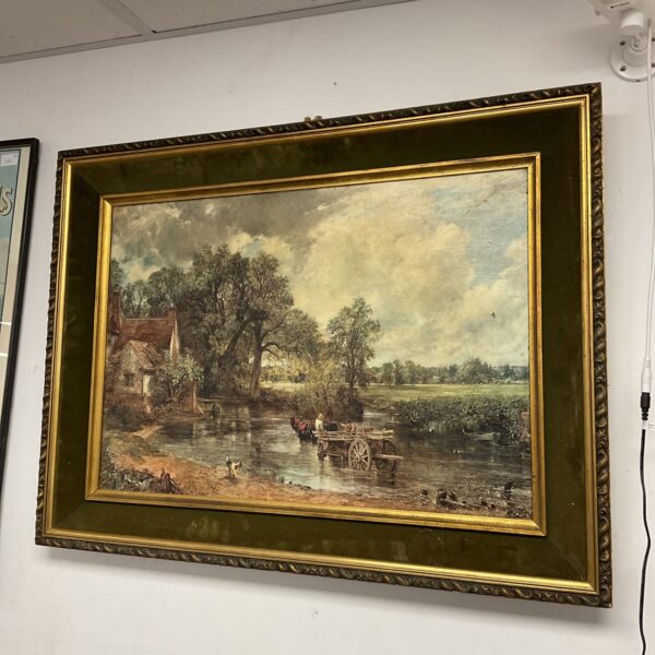 Vintage John Constable Haywain print in a gold frame.