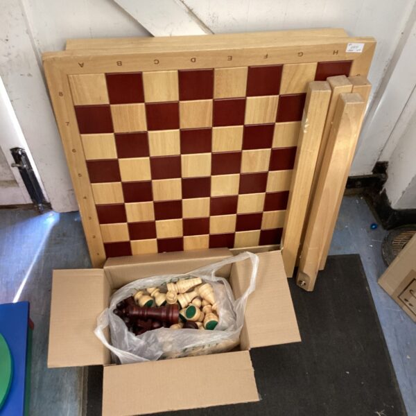 Large pine chess table with substantial wooden chess pieces.