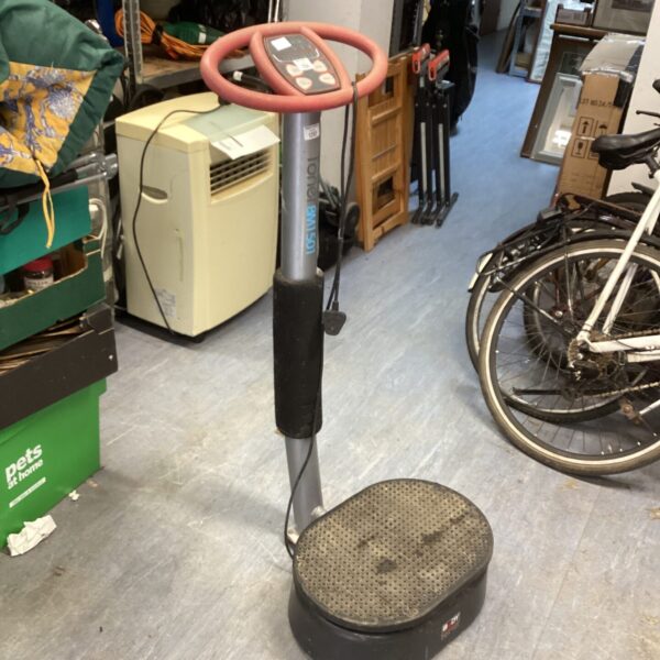 Side view of a vintage Toner vibrating machine for home fitness.