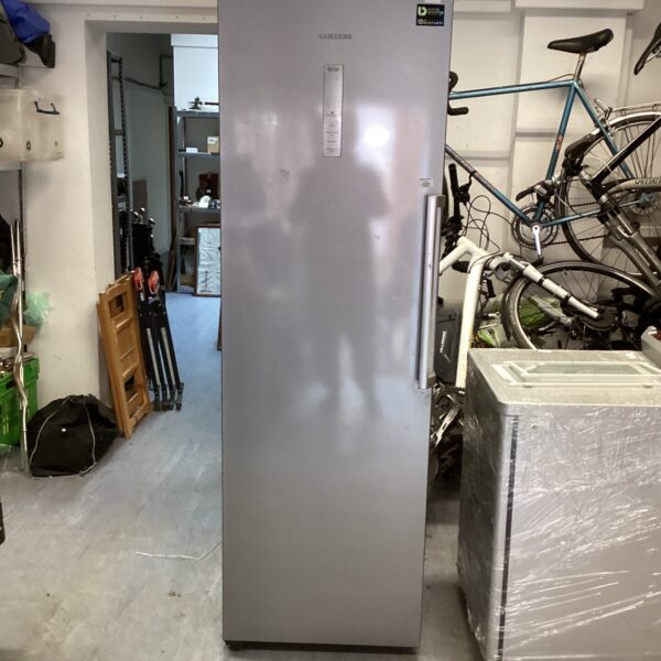 Silver Samsung upright freezer in a garage setting.