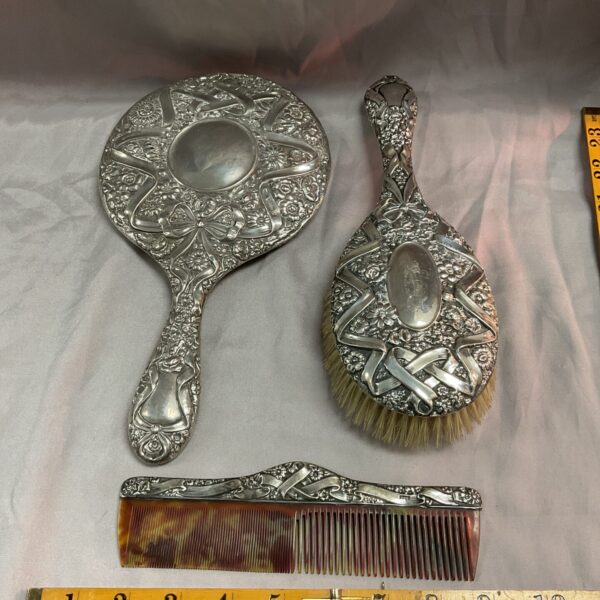 Antique Chester silver dressing table set featuring mirror, brush and comb.