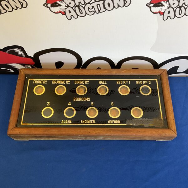 Antique Victorian butlers bell board with numbered slots.